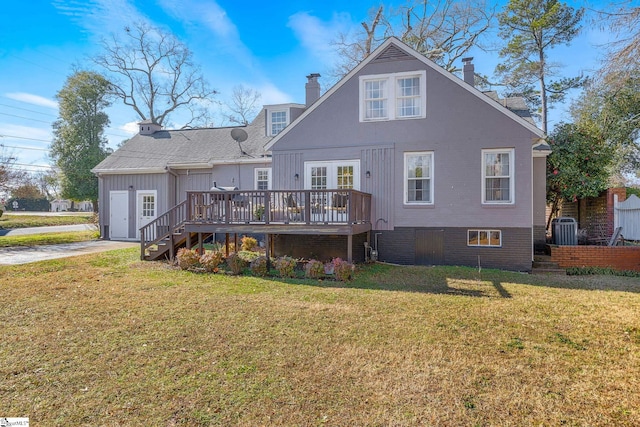 rear view of property featuring central air condition unit, a yard, and a wooden deck