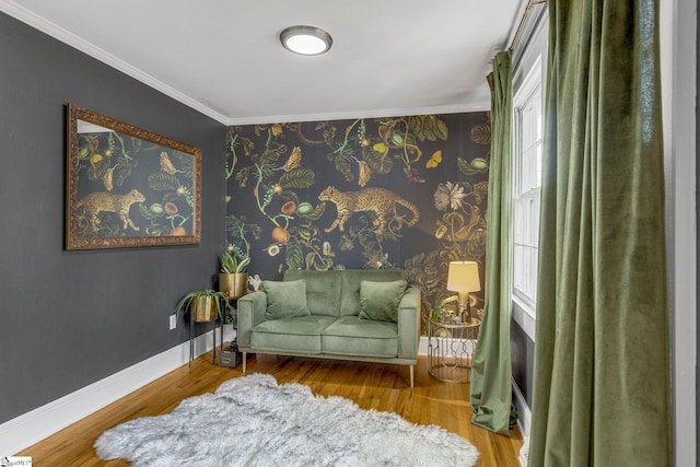 living area with crown molding and hardwood / wood-style floors