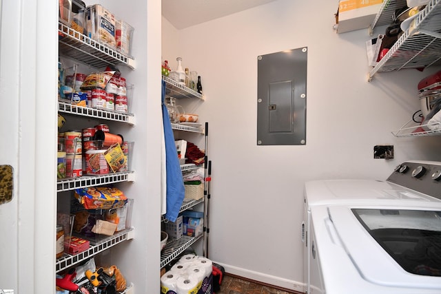 clothes washing area with electric panel and washing machine and dryer