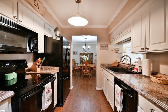 kitchen featuring sink, white cabinetry, black appliances, and hanging light fixtures