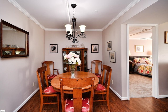 dining room with an inviting chandelier, crown molding, and dark wood-type flooring