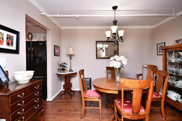 dining room with a notable chandelier, dark wood-type flooring, and crown molding