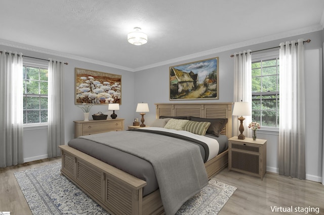 bedroom featuring light wood-type flooring, ornamental molding, and a textured ceiling