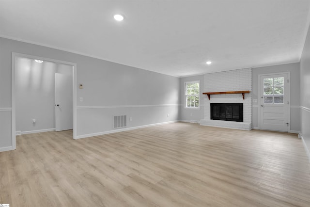 unfurnished living room featuring a fireplace and light hardwood / wood-style flooring