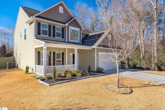 view of front of home with a porch, central AC, a front lawn, and a garage