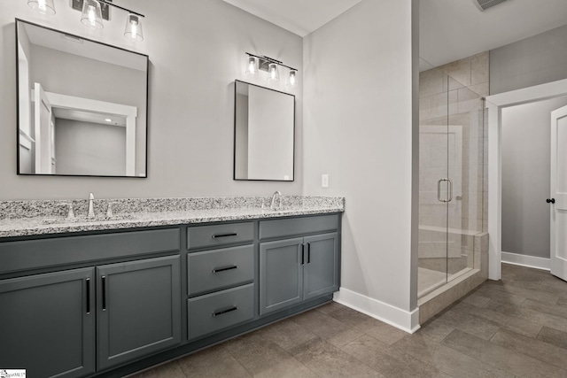 bathroom with vanity and a shower with shower door