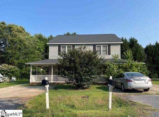 view of front facade with a porch and a front lawn