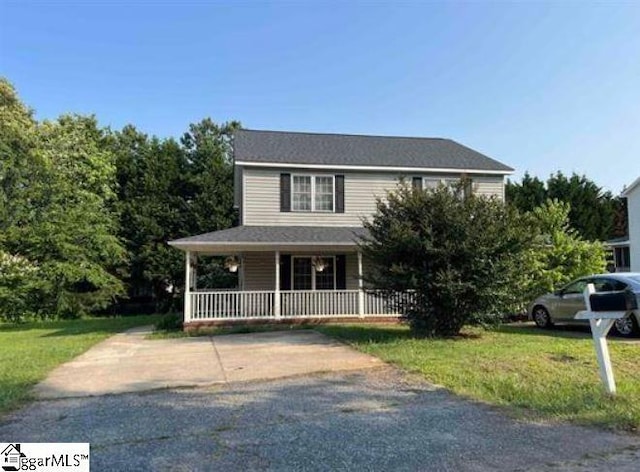 view of front facade with a porch and a front yard