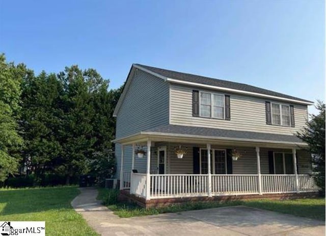 view of front of house with a porch and a front lawn