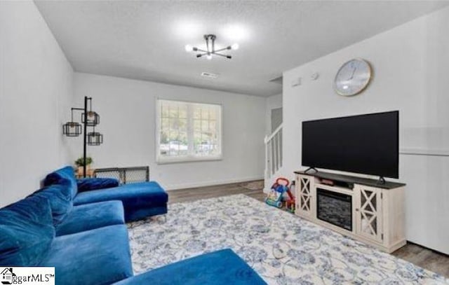 living room featuring hardwood / wood-style floors and a chandelier