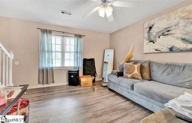 living room with ceiling fan and hardwood / wood-style floors