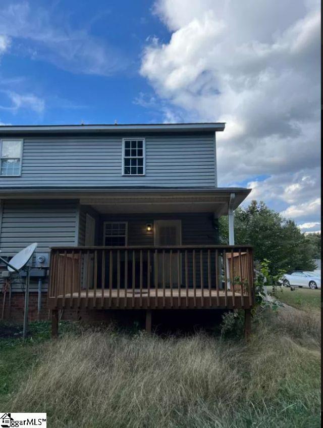 rear view of property with a wooden deck