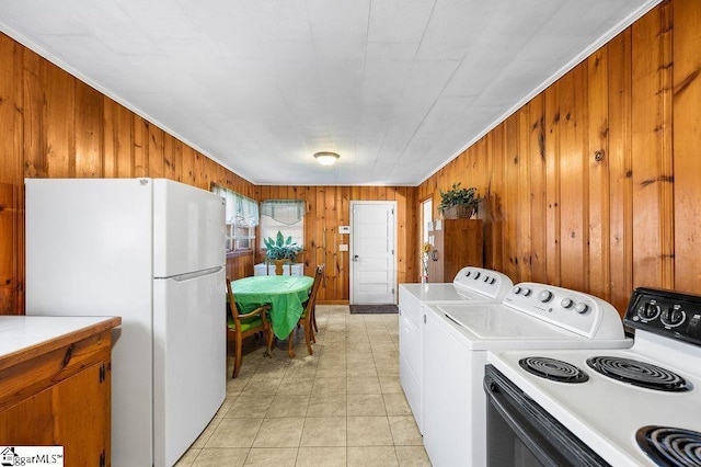 laundry room featuring washer / clothes dryer, wooden walls, and crown molding