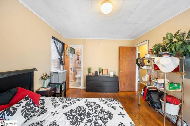 bedroom with ensuite bath, hardwood / wood-style flooring, and crown molding