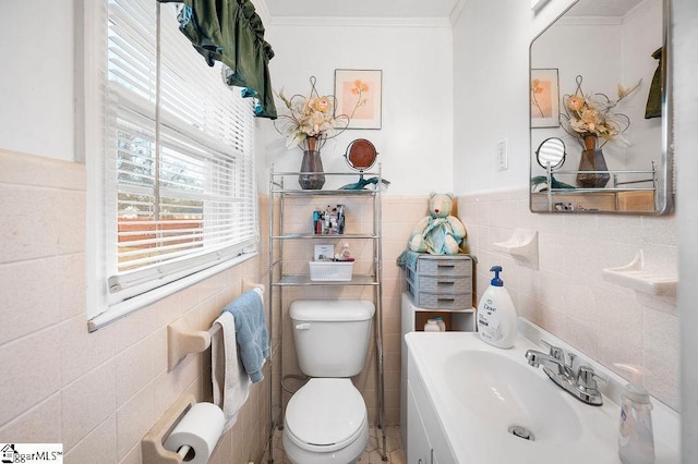 bathroom featuring tile walls, crown molding, vanity, and toilet