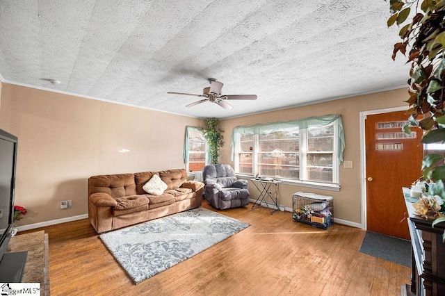 living room with a textured ceiling, ceiling fan, and hardwood / wood-style floors