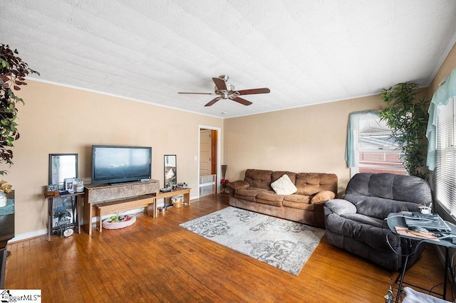 living room with a textured ceiling, ceiling fan, and hardwood / wood-style flooring