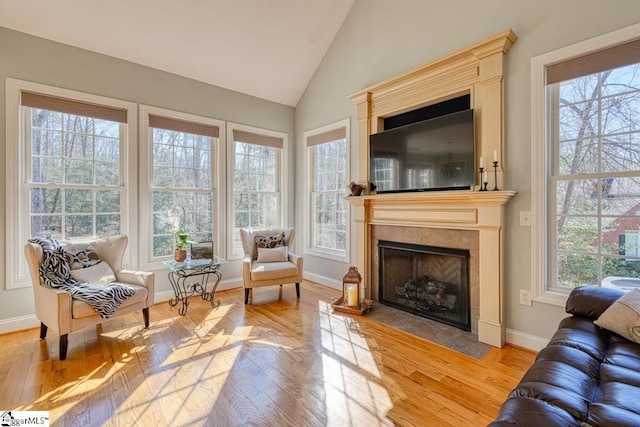 sunroom / solarium with lofted ceiling and a fireplace