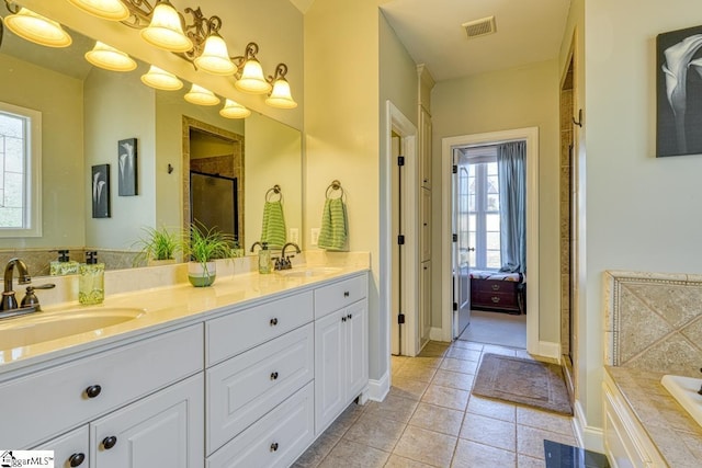 bathroom featuring tile patterned floors, independent shower and bath, and vanity