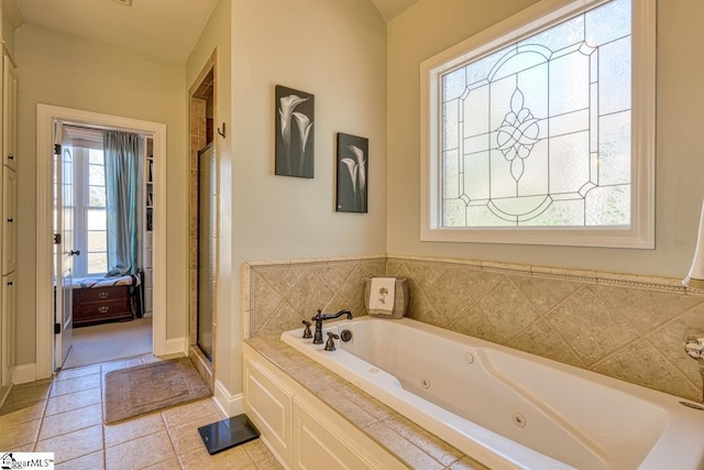 bathroom with separate shower and tub, vaulted ceiling, and tile patterned floors