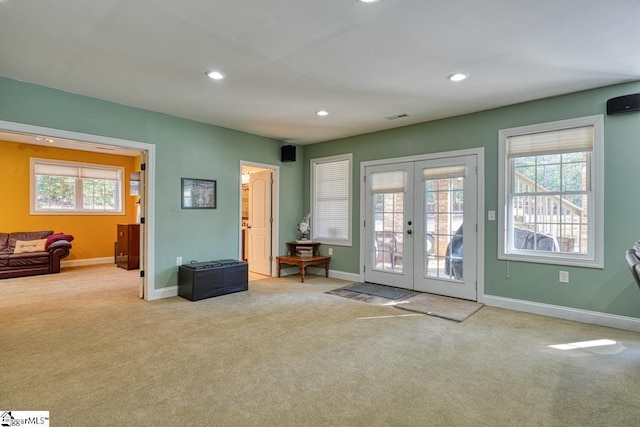 entryway with french doors and light colored carpet