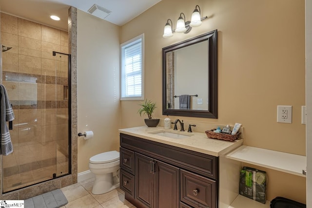 bathroom featuring toilet, tile patterned flooring, a shower with shower door, and vanity