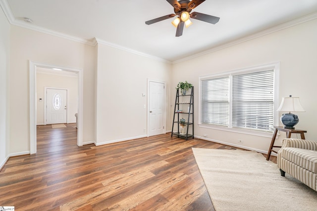 unfurnished room with ornamental molding, ceiling fan, and dark wood-type flooring