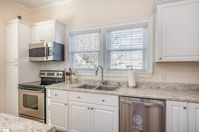 kitchen with sink, white cabinets, crown molding, and appliances with stainless steel finishes