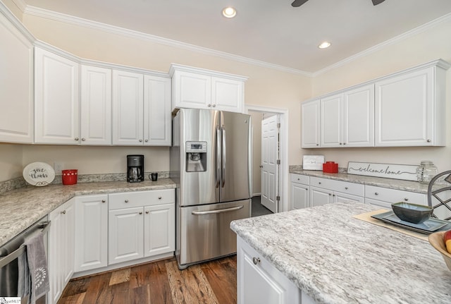 kitchen with dark hardwood / wood-style floors, white cabinetry, ornamental molding, and appliances with stainless steel finishes