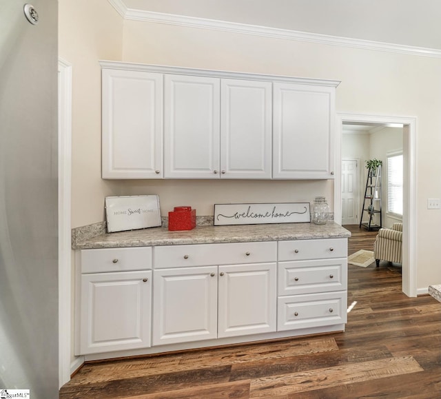 kitchen featuring ornamental molding, white cabinetry, and dark hardwood / wood-style floors