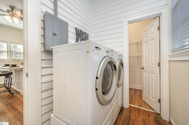 clothes washing area with washer and dryer, electric panel, dark hardwood / wood-style flooring, ornamental molding, and ceiling fan