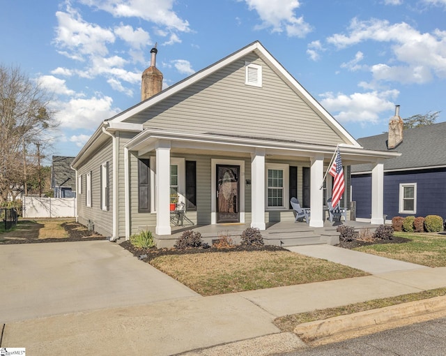 bungalow-style home featuring a porch and a front yard