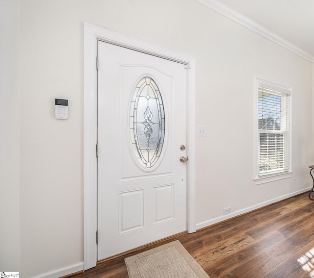 foyer featuring dark wood-type flooring and ornamental molding