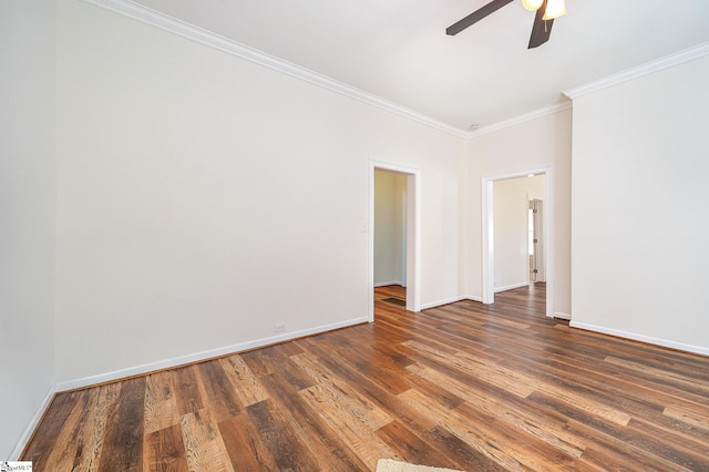 spare room with dark hardwood / wood-style flooring, ornamental molding, and ceiling fan