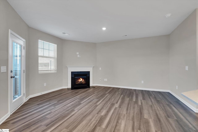 unfurnished living room with wood-type flooring