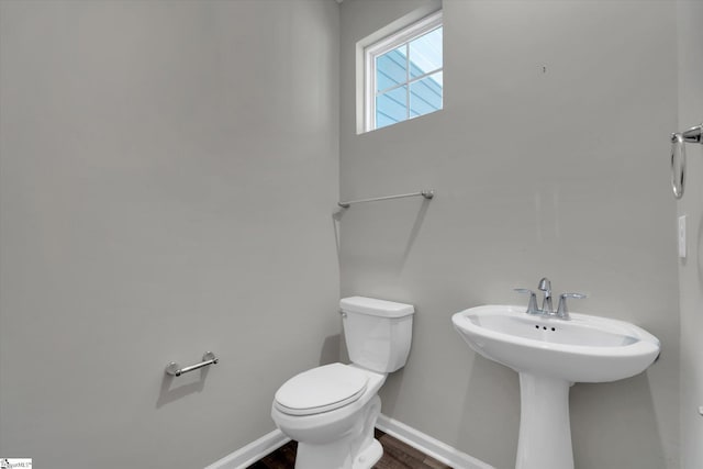 bathroom featuring toilet and hardwood / wood-style flooring