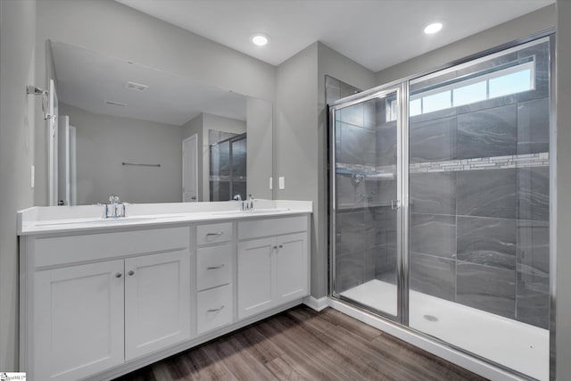 bathroom with vanity, hardwood / wood-style floors, and a shower with shower door