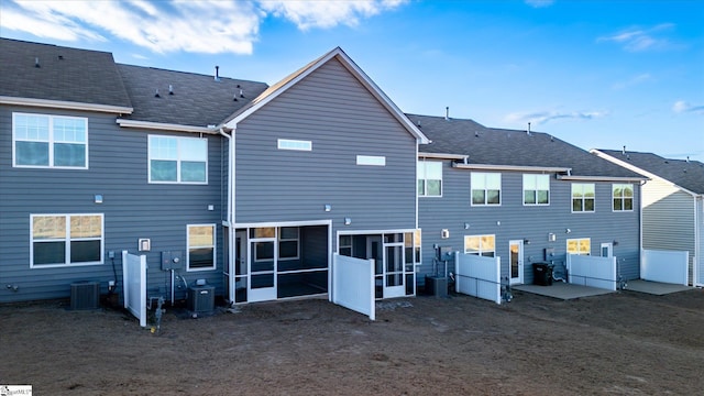 back of house featuring central air condition unit and a sunroom