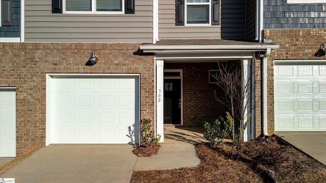 doorway to property with a garage