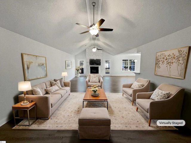 living room with lofted ceiling, ceiling fan, and hardwood / wood-style floors