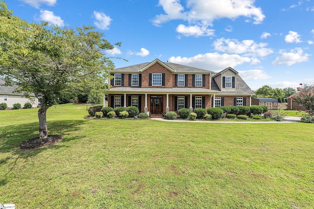 view of front of home featuring a front yard and covered porch