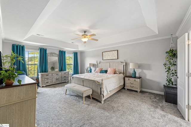 bedroom featuring ornamental molding, a raised ceiling, carpet floors, and ceiling fan