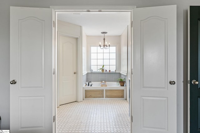 bathroom featuring a notable chandelier