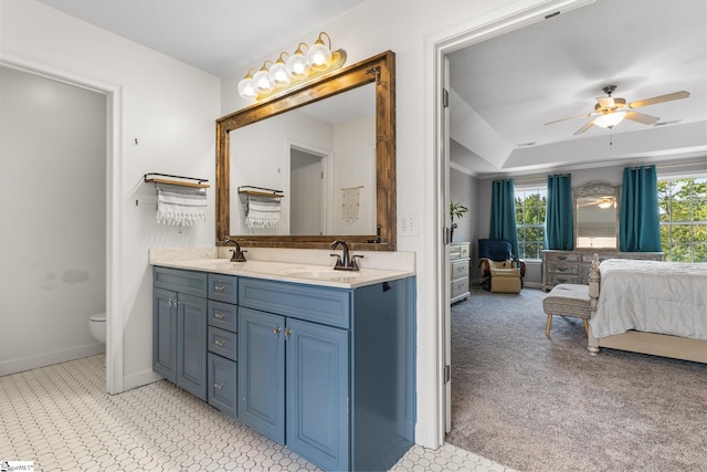 bathroom featuring toilet, ceiling fan, and vanity