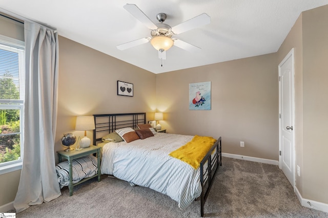 bedroom featuring ceiling fan, multiple windows, and carpet