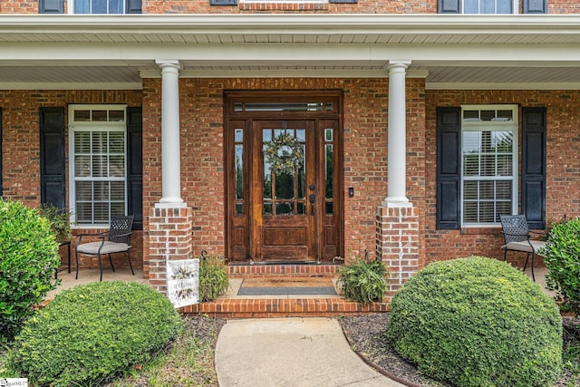 doorway to property featuring covered porch