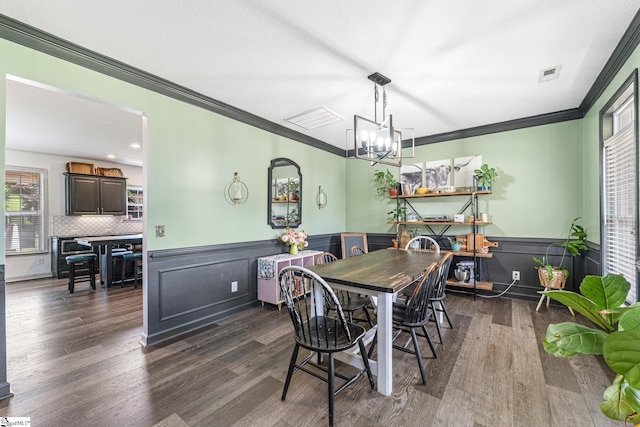 dining area with crown molding and dark hardwood / wood-style flooring