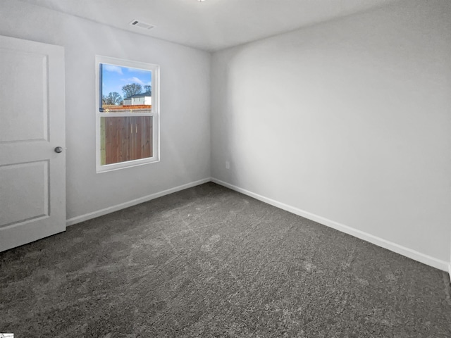 empty room with dark colored carpet