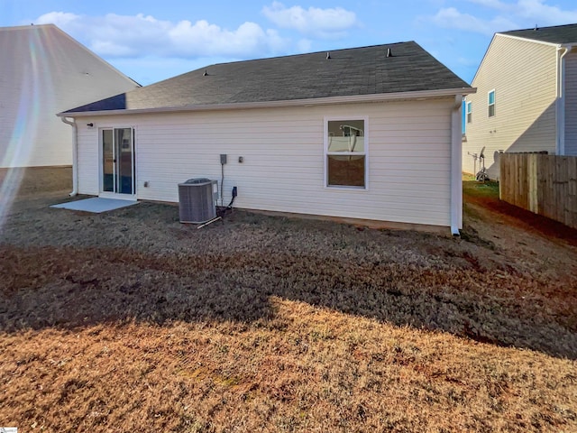 rear view of house featuring cooling unit