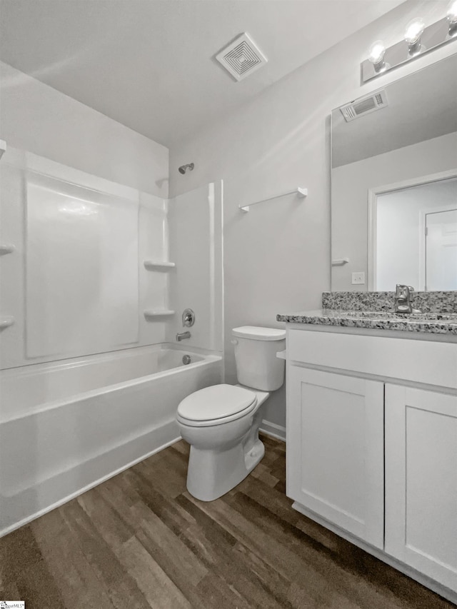 full bathroom featuring wood-type flooring, shower / tub combination, vanity, and toilet